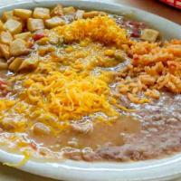 Huevos Rancheros · Plate. Two eggs, potatoes, beans and tortilla smothered with choice of chili.