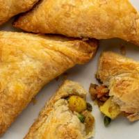 Vegetable Samosa · 2 deep-fried pastries stuffed with potatoes, peas, and spices. Vegan.