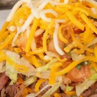 Meat Tostada · Crispy flat corn tortilla topped with your choice of meat, beans, lettuce, cheese and salsa ...