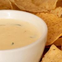 Con Queso Dip · Our signature spinach cheese sauce served with fresh daily made tortilla chips.