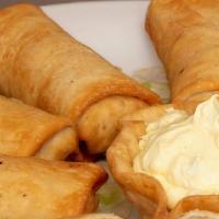 Mini Chimis · 3 chicken and 3 beef mini chimis served with your choice of guacamole, sour cream or jalapen...