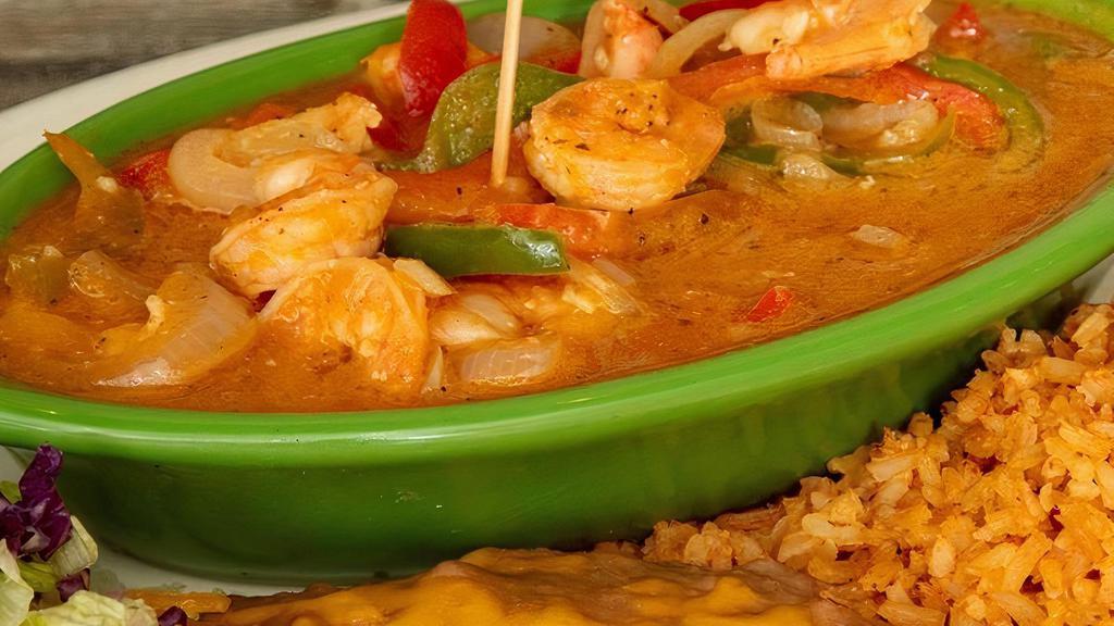 Camarones Rancheros · Sauteed shrimp tossed with ranchera sauce, bell peppers, onions and served with rice, beans and a flour tortilla.