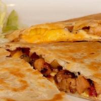 Chicken Mango Quesadilla · A fresh flour tortilla filled with sauteed chicken, blend of cheeses, mango and our signatur...