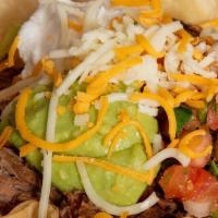 Taco Salad · A crispy flour tortilla shell filled with fresh lettuce and your choice of shredded beef, as...