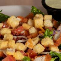 Crispy Chicken Salad · Crispy chicken breast tenders, smoked bacon, tomato, cheese and fresh salad greens with your...