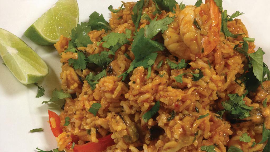 Arroz Con Mariscos · Rice cooked in hot sauce with seafood.