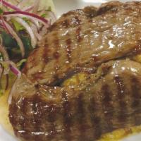 Tacu Tacu Con Bistec · Sautéed mix of rice with beans topped with steak.