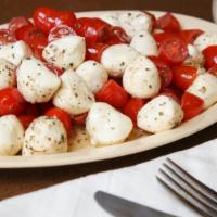 Capri Salad · Fresh mozzarella cheese, cherry tomatoes, basil, black pepper & olive oil.