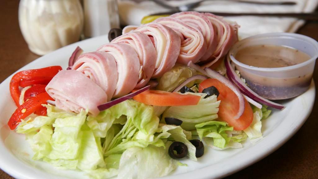 Antipasto Salad · Lettuce, tomatoes, olives, red onions, ham, salami, provolone cheese, prosciutto, roasted peppers, marinated mushrooms, spicy pepperoncini, oil & vinegar dressing.