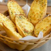 Garlic Bread With Cheese · Fresh baked garlic bread topped with creamy cheese.