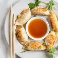 Potstickers · Individually hand made, filled with ground pork, ginger napa cabbage while folded in a pastr...