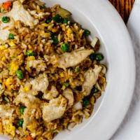 Chicken Fried Rice · Authentic fried rice cooked with eggs, peas and carrots, and green onions with chicken