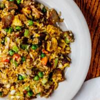 Pork Fried Rice · Authentic fried rice cooked with eggs, peas and carrots, and green onions with pork