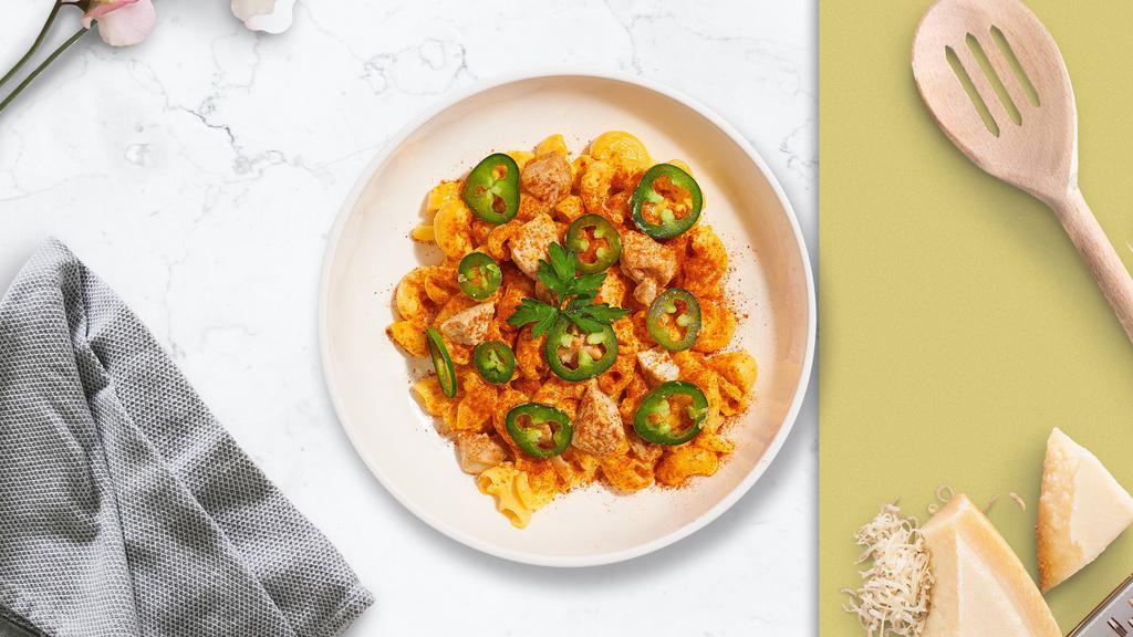 Hot Chick Mac · Spicy fried chicken, chipotle cheese sauce, and jalapenos cooked in a blend of creamy cheese.