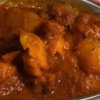 Chicken Vindaloo · Pieces of chicken cooked in a highly seasoned gravy, with potatoes, tomatoes, vinegar, jagge...