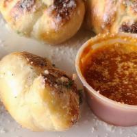 Garlic Knots · 8 freshly made pizza dough knots tossed in garlic butter. Served with side of house made mar...