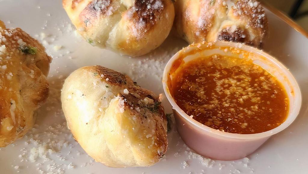 Garlic Knots · 8 freshly made pizza dough knots tossed in garlic butter. Served with side of house made marinara sauce.