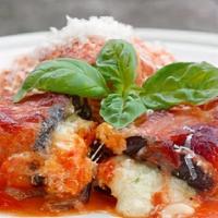 Baked Eggplant Rollatini · Sliced baked eggplant stuffed with ricotta and mozzarella cheese and basil topped marinara s...