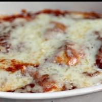 Baked Cheese Ravioli · Pockets of pasta stuffed with ricotta cheese covered with house made marinara sauce and fres...