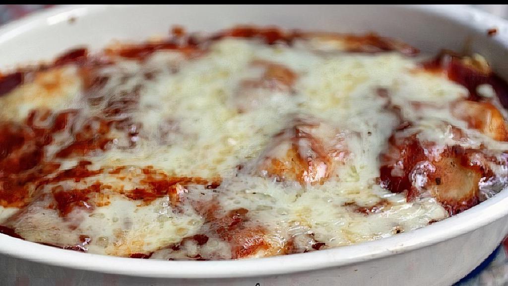 Baked Cheese Ravioli · Pockets of pasta stuffed with ricotta cheese covered with house made marinara sauce and fresh mozzarella cheese and baked to a golden brown.