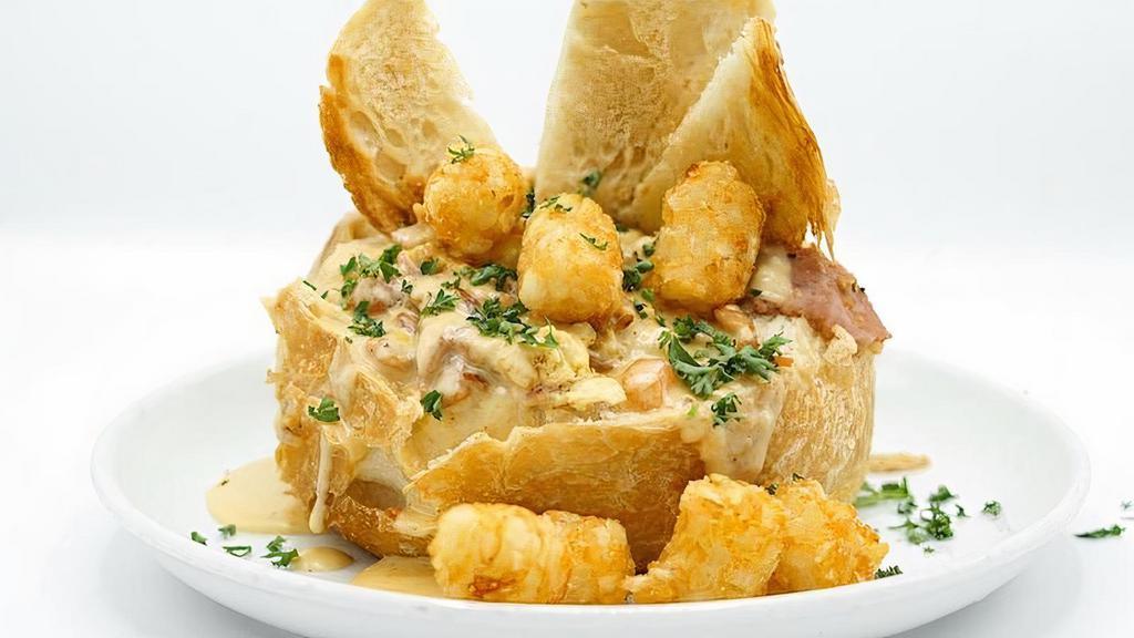Brekky Bread Bowl · scrambled eggs, sugardale ham, pepper jack, cheddar, tomato, cheese fondue, sourdough bread bowl