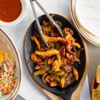 Fajitas · Marinated strips of Steak or Chicken sautéed with Green Peppers and Onions served with Rice ...