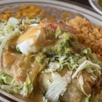 Chimichanga · Fried Burrito filled with Chicken or Shredded Beef, served with Rice and Beans, side of Lett...