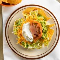 Taco Salad · Tortilla Shell filled with Chicken or Shredded Beef, Beans, Cheese and Lettuce, side of Guac...