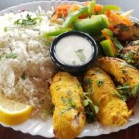 Shish Taouk · Chicken marinated in garlic, oregano, saffron, and other middle eastern spices. Served on a ...