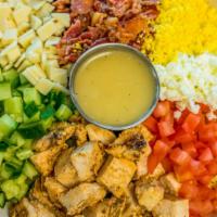 Wood Grilled Chicken Cobb Salad · Diced Marinated Chicken Breast, Cucumber and Tomatoes, Hard Boiled Eggs, White Cheddar Chees...