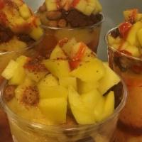 Mangoniada · Blended ice with mango syrup, tamarind candies, Japanese style Peanuts, fresh mango, tajin, ...
