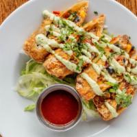 Crispy Pork Joints · Pulled pork, monterey jack, black bean and corn salsa, rolled in a wonton with avocado crema...