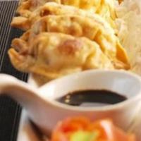 Japanese Gyoza · Deep-fried chicken and vegetables dumplings are, served with a soy sauce.