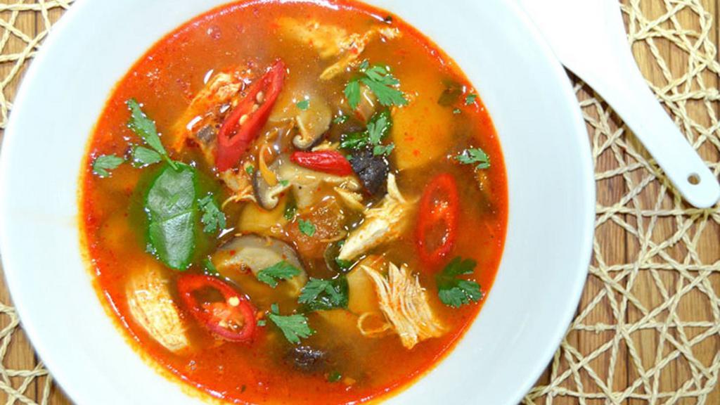 Tom Yum · Thai style and sour clear soup with a touch of lemongrass, kaffir lime leaves, chili paste, galangal, green onion, tomato, mushrooms, lime juice, and sprinkled with cilantro.