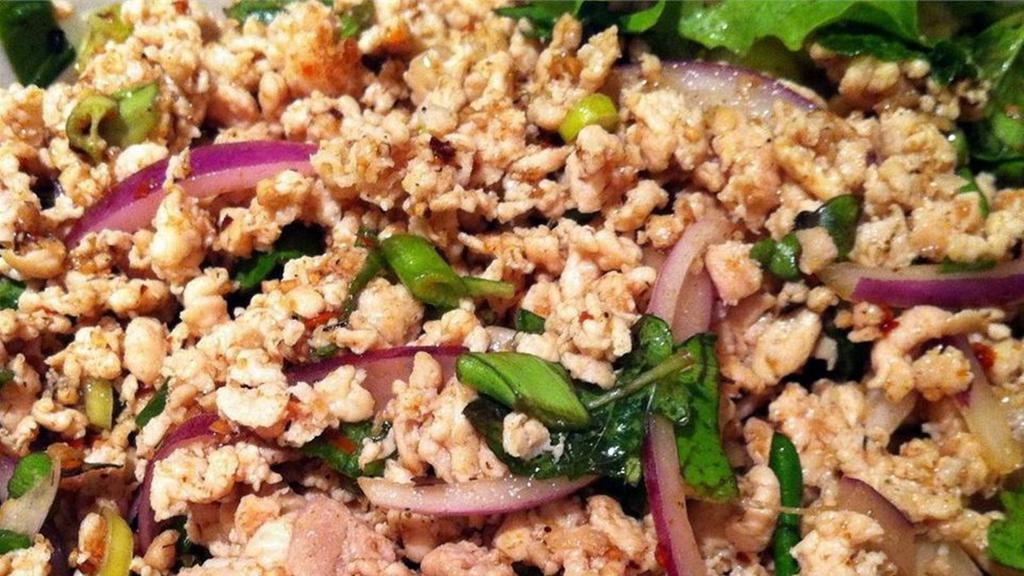 Larb · Ground chicken breast or pork mixed with roasted chili powder, roasted sticky rice powder, mint leaves, red onions, green onions, lime dressing, kaffir lime leaves, fish sauce, and cilantro.