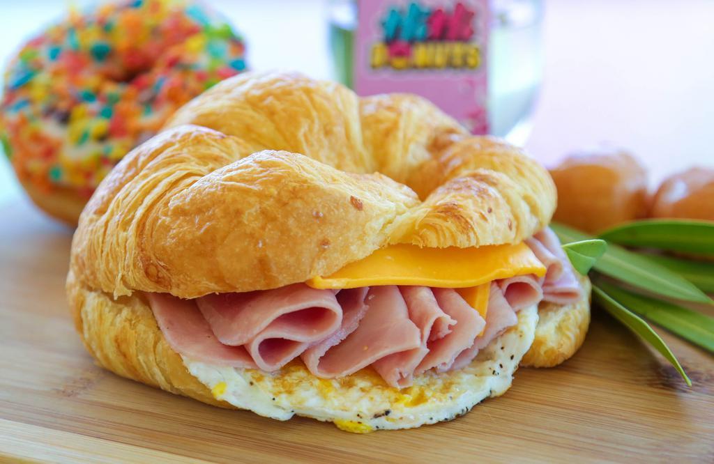 Croissant Breakfast Sandwich 🥐 · Freshly baked buttery croissant served with Egg, Cheese & Choice of Protein