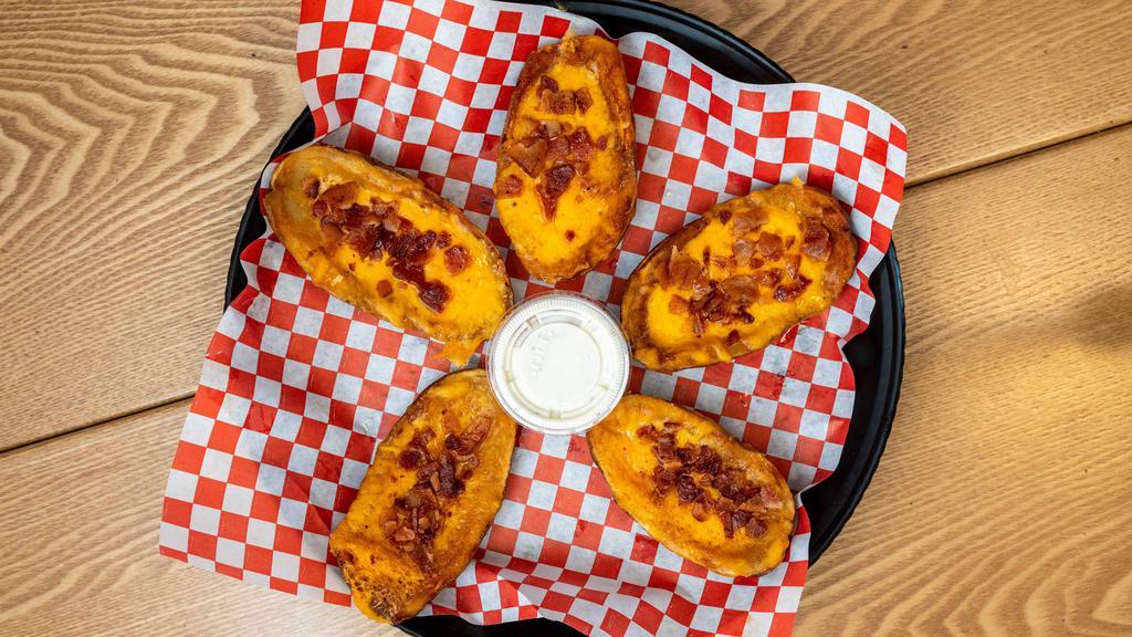 Potato Skins · Cheddar cheese, bacon and ranch dressing.