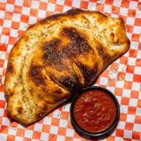 Calzone · A calzone is an Italian oven-baked turnover made with folded pizza dough. It originated in N...