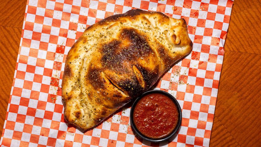 Calzone · A calzone is an Italian oven-baked turnover made with folded pizza dough. It originated in Naples in the 18th century. A typical calzone is made from salted bread dough, baked in an oven, mozzarella, ricotta and Parmesan. Mozzarella and marinara sauce baked with your choice of items.