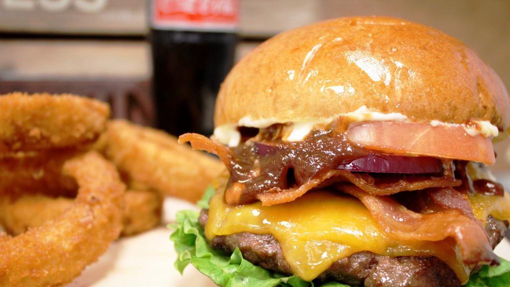 Tex Burger*
 · Lettuce, tomatoes, red onions, bacon, spicy BBQ, cheddar cheese