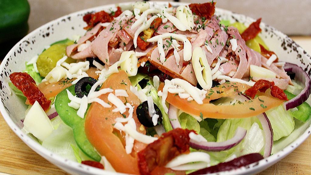 Antipasto Salad · Provolone cheese, sun-dried tomatoes, and sliced variety of meats. All served on a bed of lettuce mixture and other fresh garden vegetables with your choice of dressings.