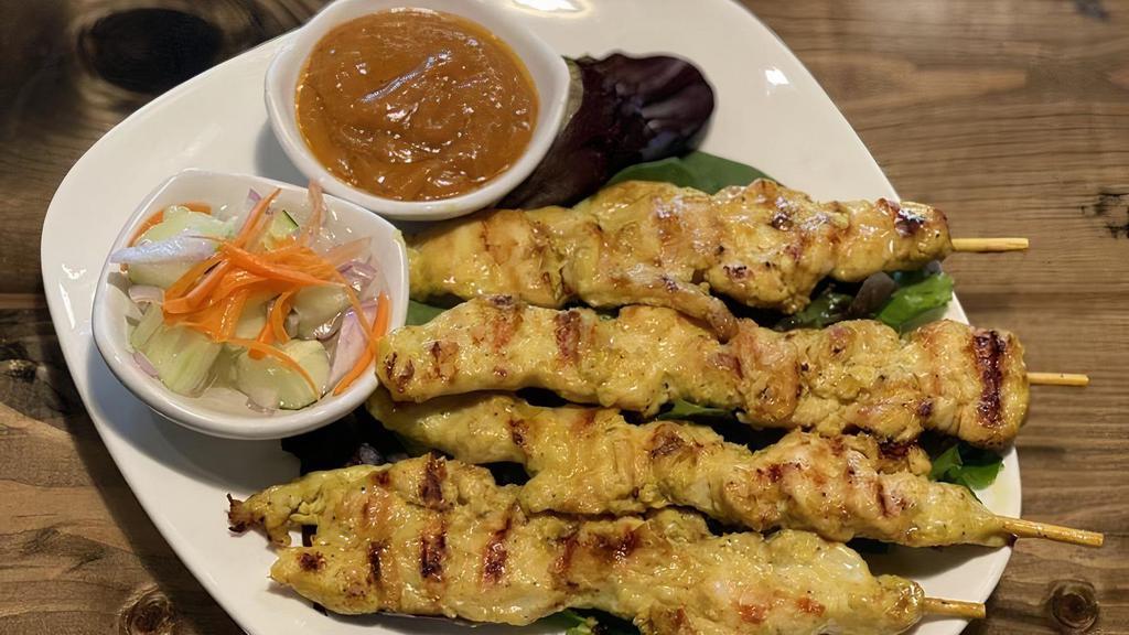 Chicken Satay · Grilled marinated chicken skewers served with peanut sauce and cucumber salad.