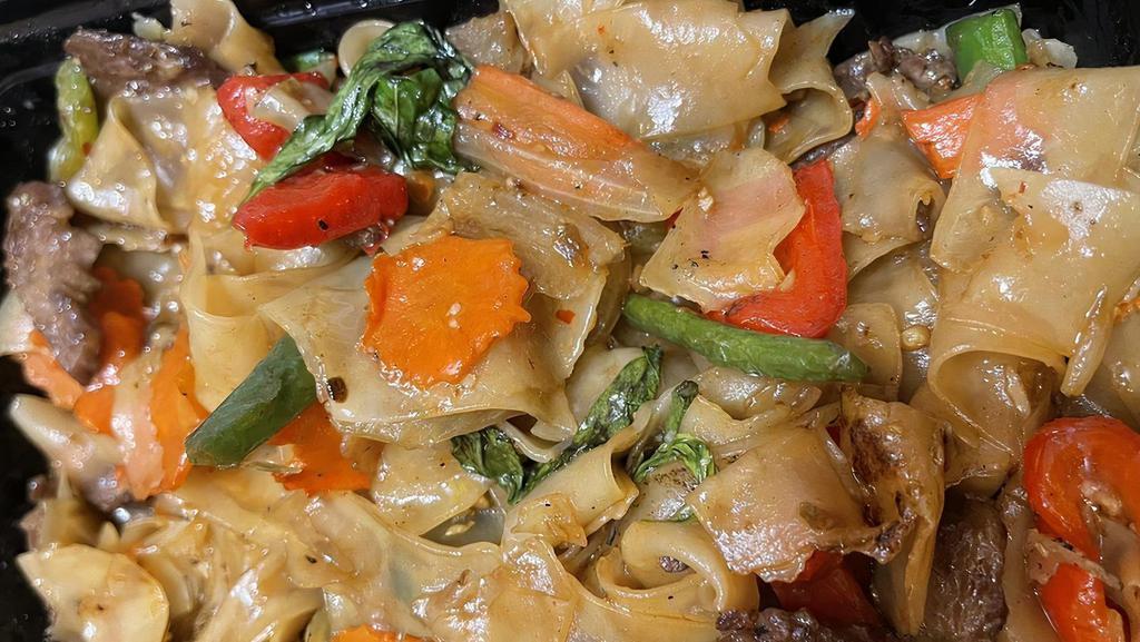 Pad Kee Mao (Drunken Noodle) · Stir fried flat rice noodles with green bean, bell pepper, thai herbs, chilies and basil with your choice of meat.
