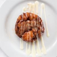 Apple Fritter · Homemade apple fritter served hot with cinnamon sugar topping and cream cheese drizzle