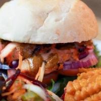 Butter Chicken Burger · Puffed chicken spiced smothered in a buttery tomato sauce and served on a brioche bun with o...