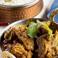 Madras Goat Curry · (GF). Southern spiced goat (bone-in) curry with mustard, fenugreek, curry leaves and sambhar...