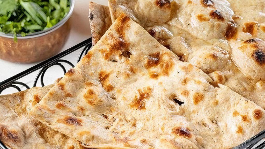 Tandoori Roti · Traditional flat breads cooked in our tandoor clay oven