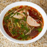 Bún Bò Huế - Hue Style Beef Noodle Soup · Large rice noodles, beef shanks, cooked pork blood with spicy beef broth, and a dish of vege...
