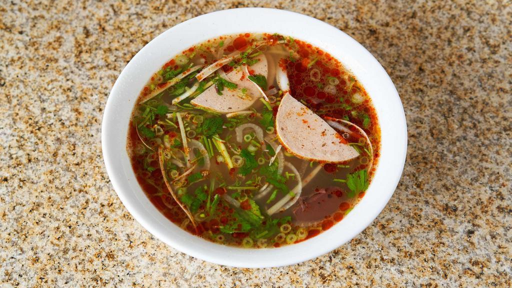 Bún Bò Huế - Hue Style Beef Noodle Soup · Large rice noodles, beef shanks, cooked pork blood with spicy beef broth, and a dish of vegetables (bean sprouts, lettuce, banana flower, mints and lime wedge).