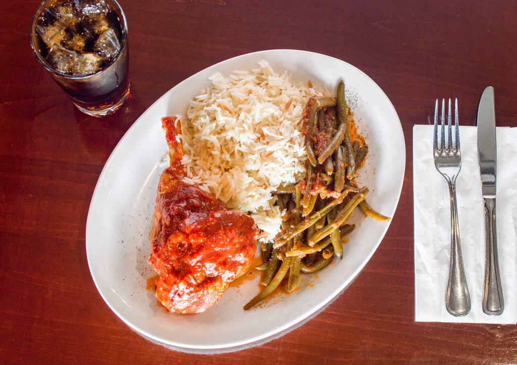 Roasted Lamb Shanks · Oven roasted lamb shanks served with green beans and Turkish rice.
